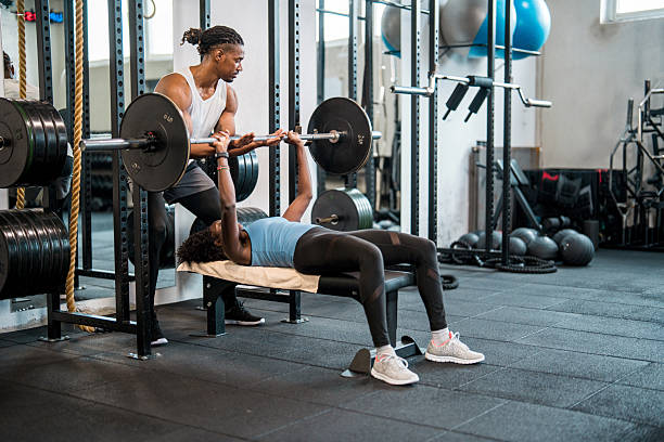 Personal trainer coaching a gym member