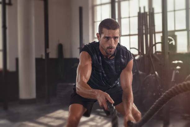 Man doing cross-training exercise with rope